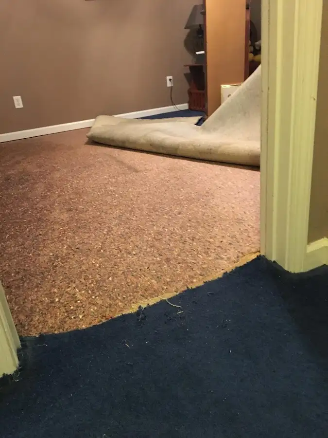 Carpet pad removal revealing water damage during Drying & Dehumidification in Groton